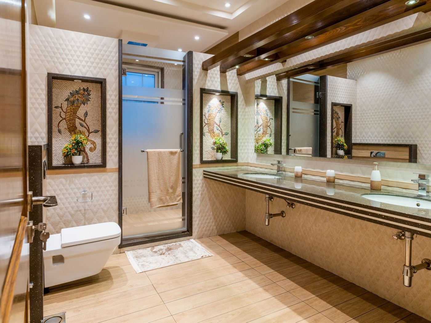 Contemporary bathroom with warm wood vanity, double sinks, and walk-in shower
