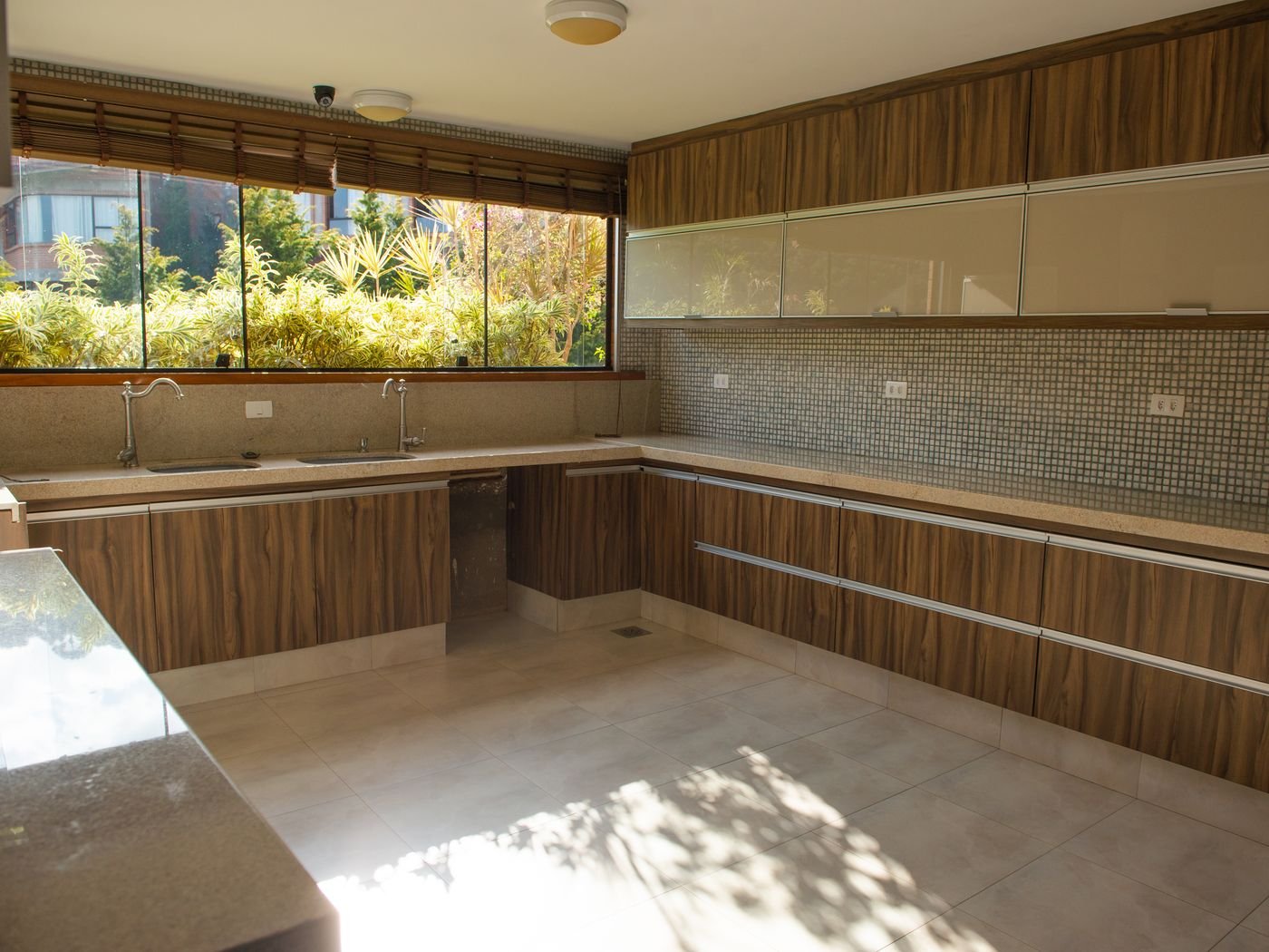 Wood-toned kitchen with dark cabinetry and coordinated living-space finishes