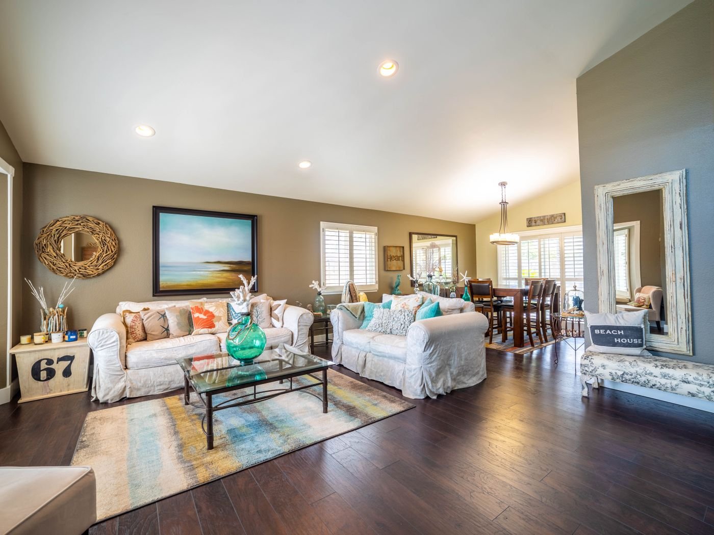 Modern living room with fireplace, natural light, and connected dining space